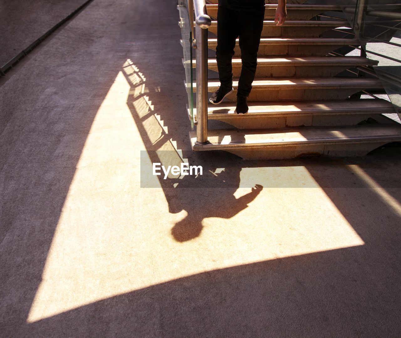 Low section of man walking on staircase