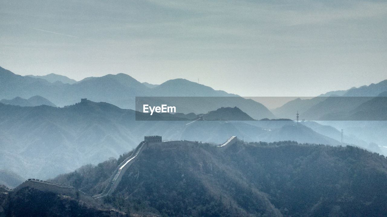 Scenic view of mountains against cloudy sky