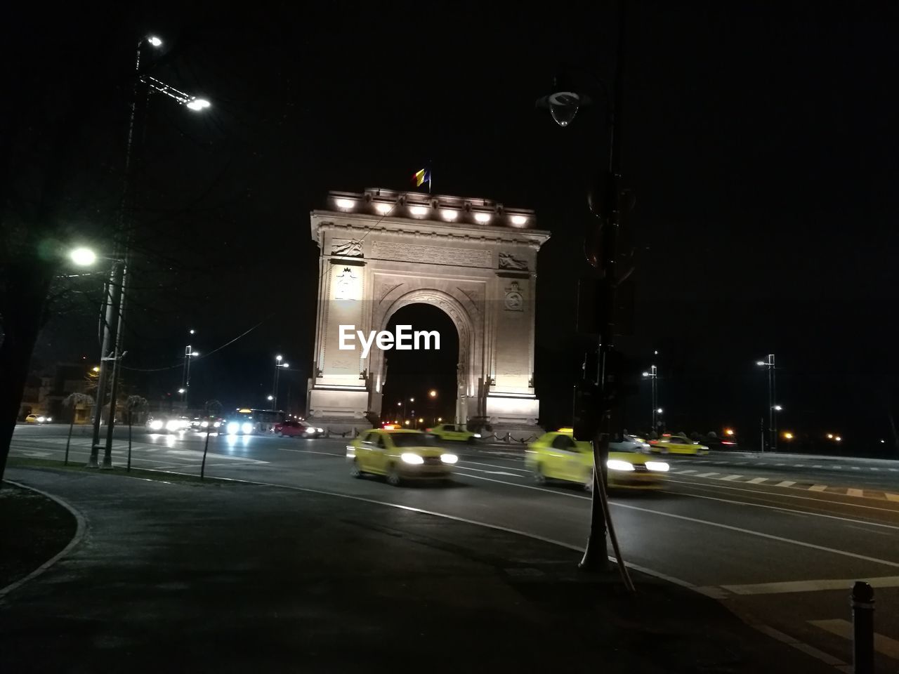 VIEW OF ILLUMINATED ROAD AT NIGHT