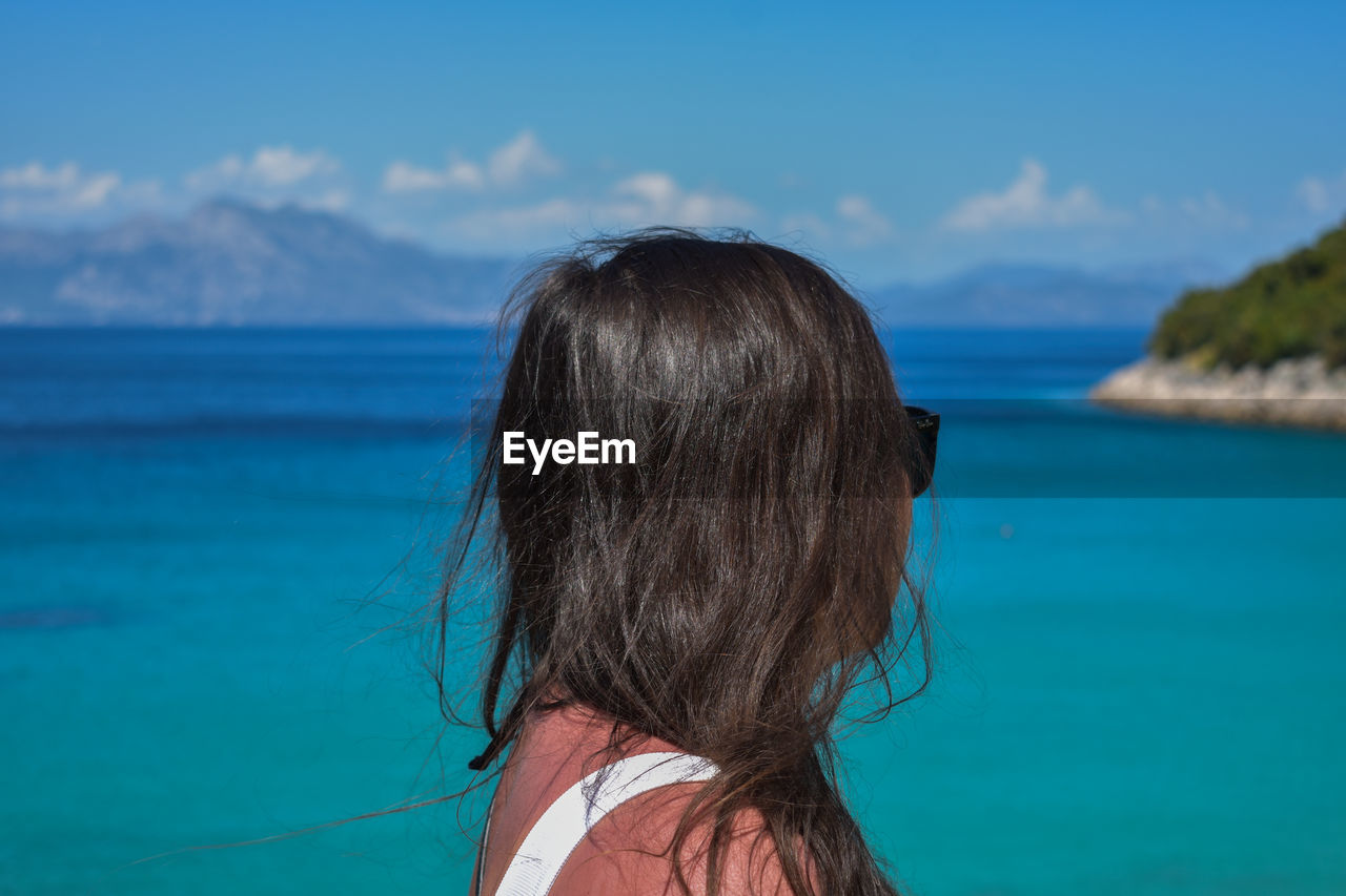 Close-up of woman standing against sea