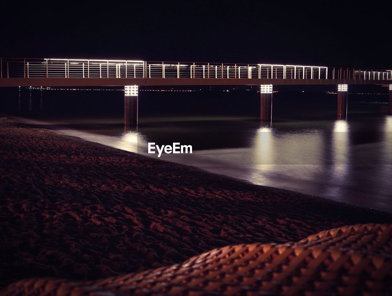 Illuminated bridge at night