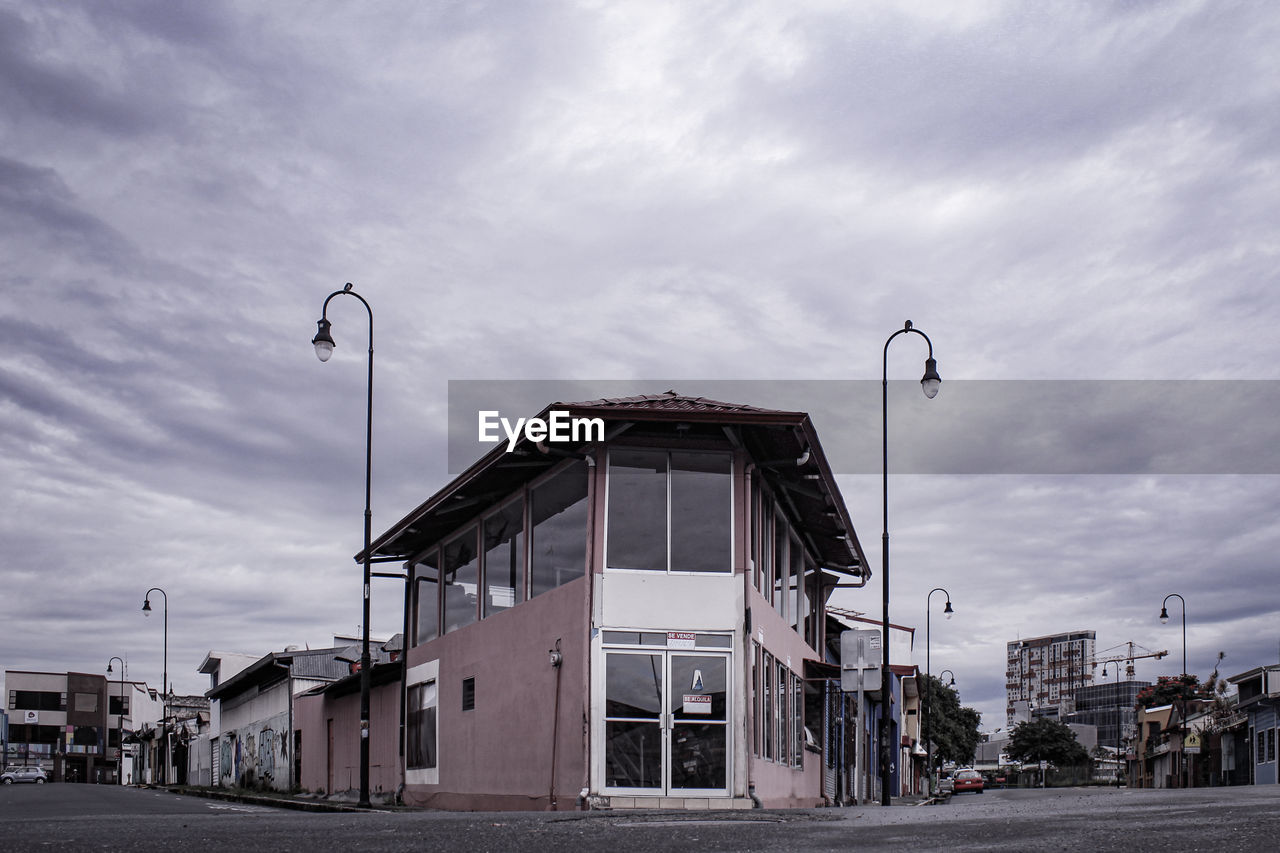 Street amidst buildings against sky in city