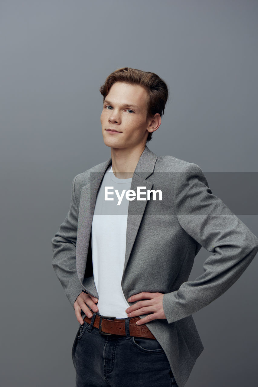 portrait of young man against gray background