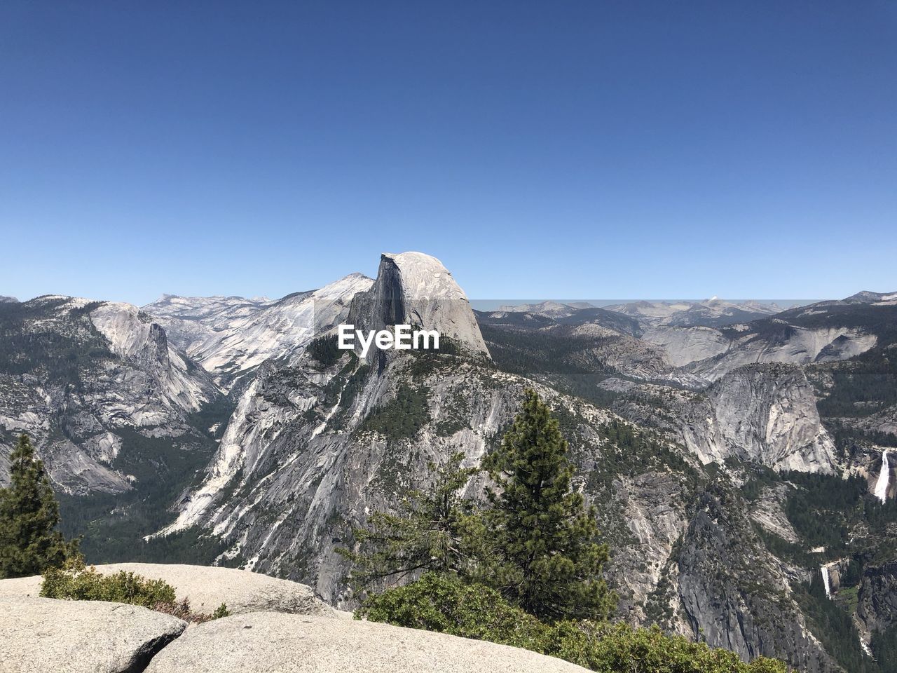 Scenic view of mountains against clear blue sky