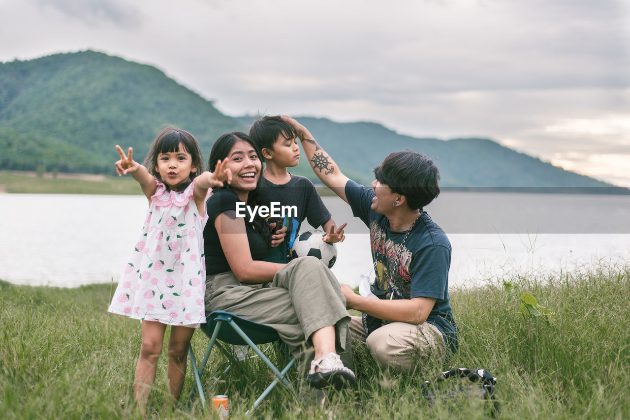 Portrait of smiling family on field