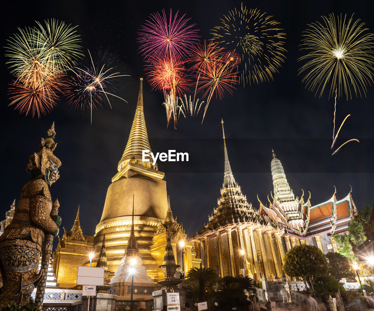 LOW ANGLE VIEW OF FIREWORK DISPLAY IN CITY AGAINST SKY