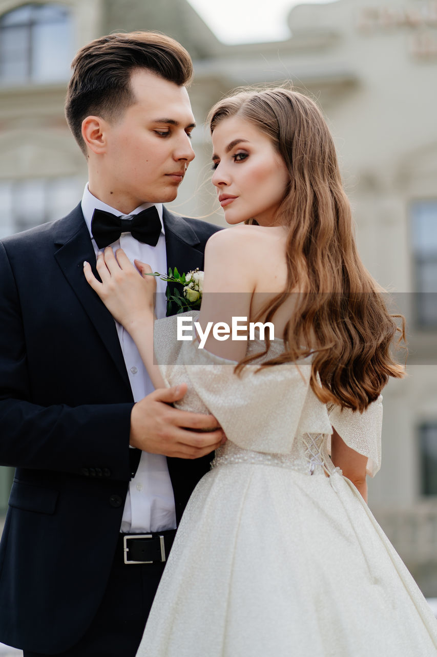 Bridegroom standing outdoors