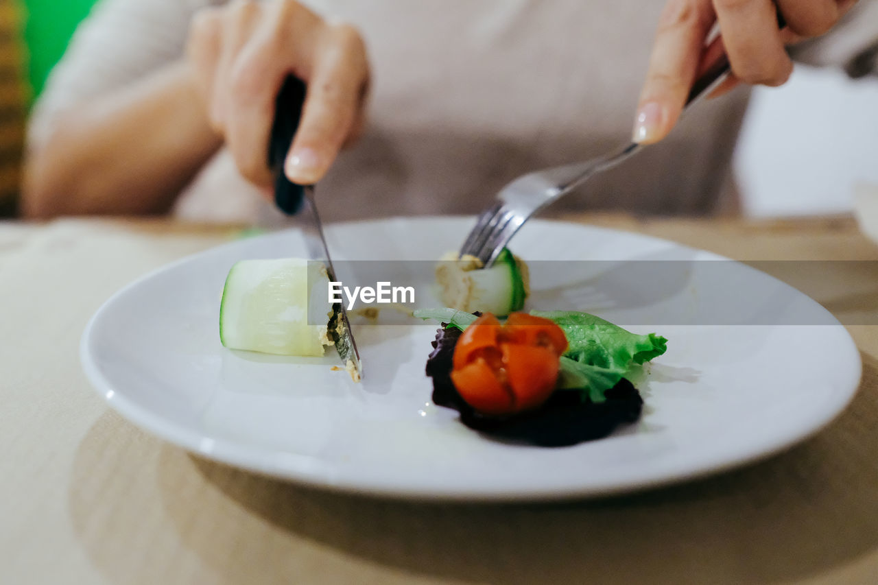 Cropped image of man with food on table