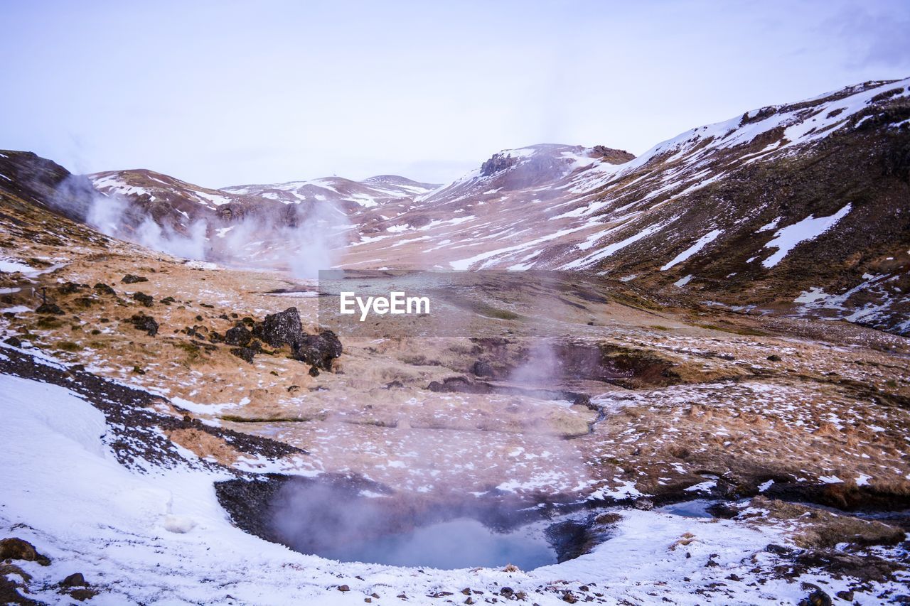 Scenic view of snowcapped mountains against clear sky