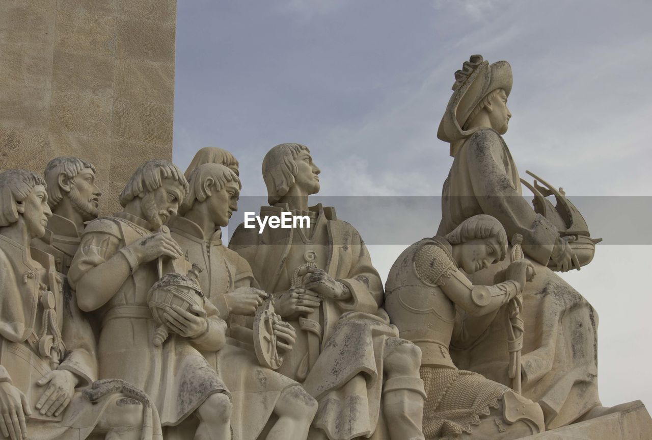 Low angle view of statues against sky