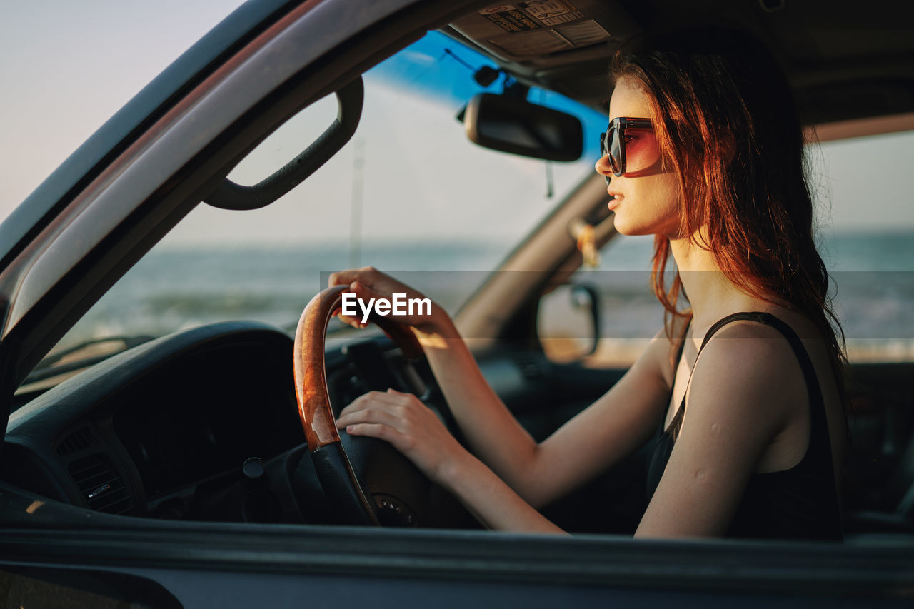 Young woman sitting in car