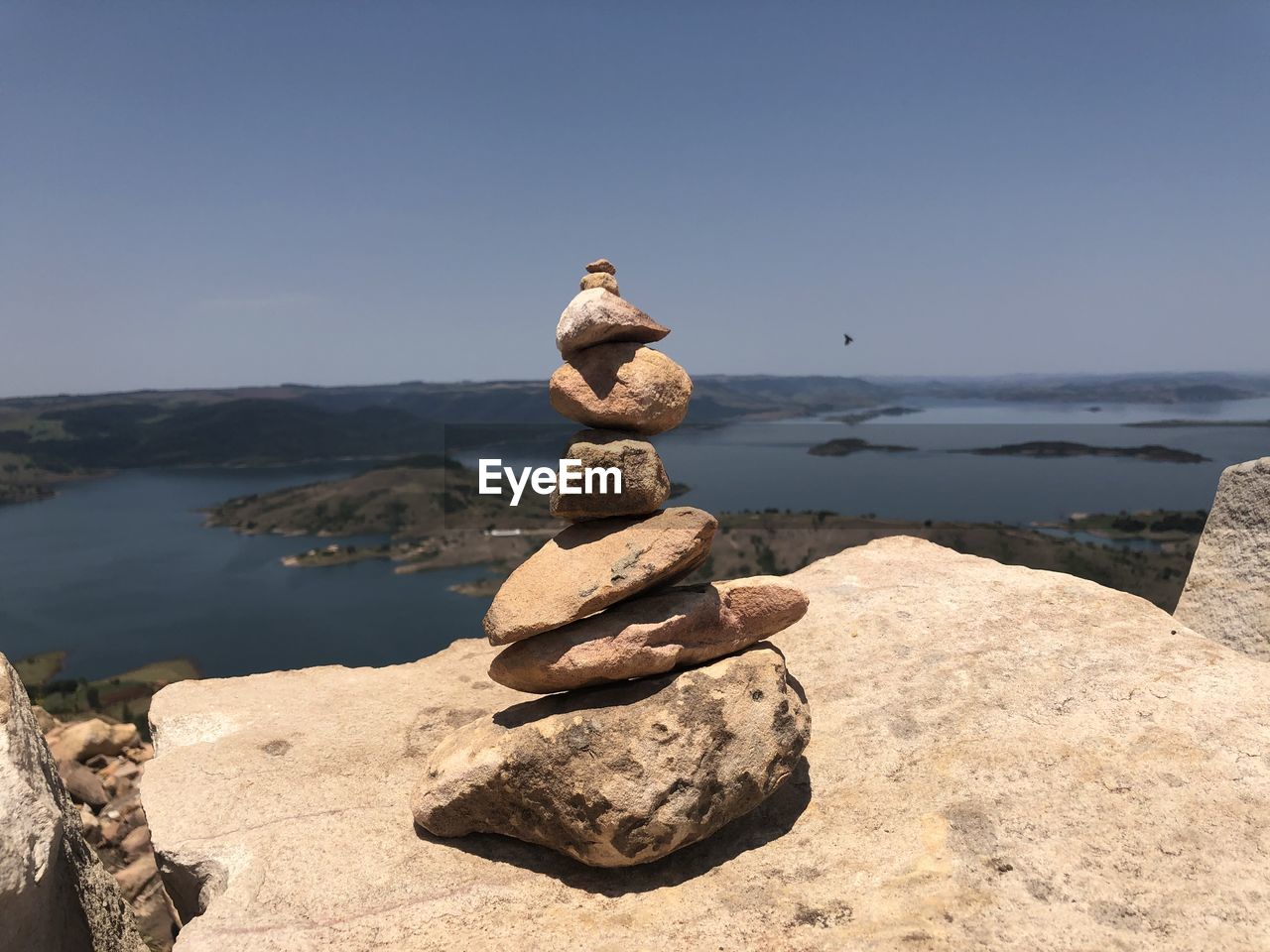 STACK OF STONES ON ROCK AGAINST SKY