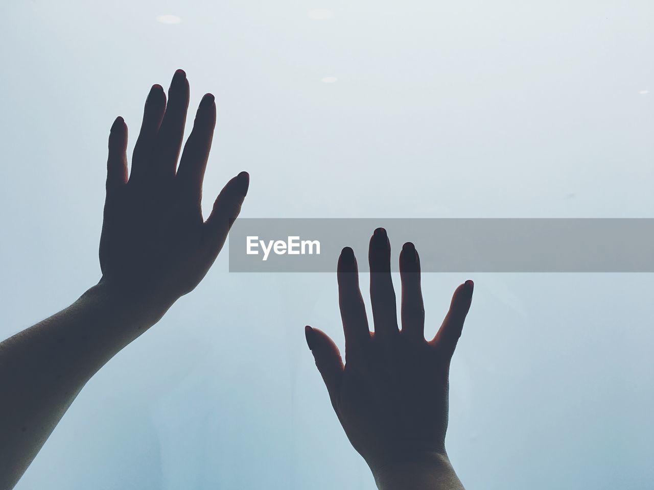 Close-up of hands against clear sky