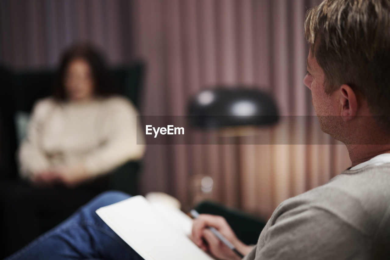 Male doctor and female patient at therapy session