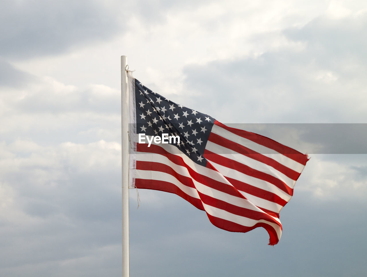 Low angle view of american flag against sky