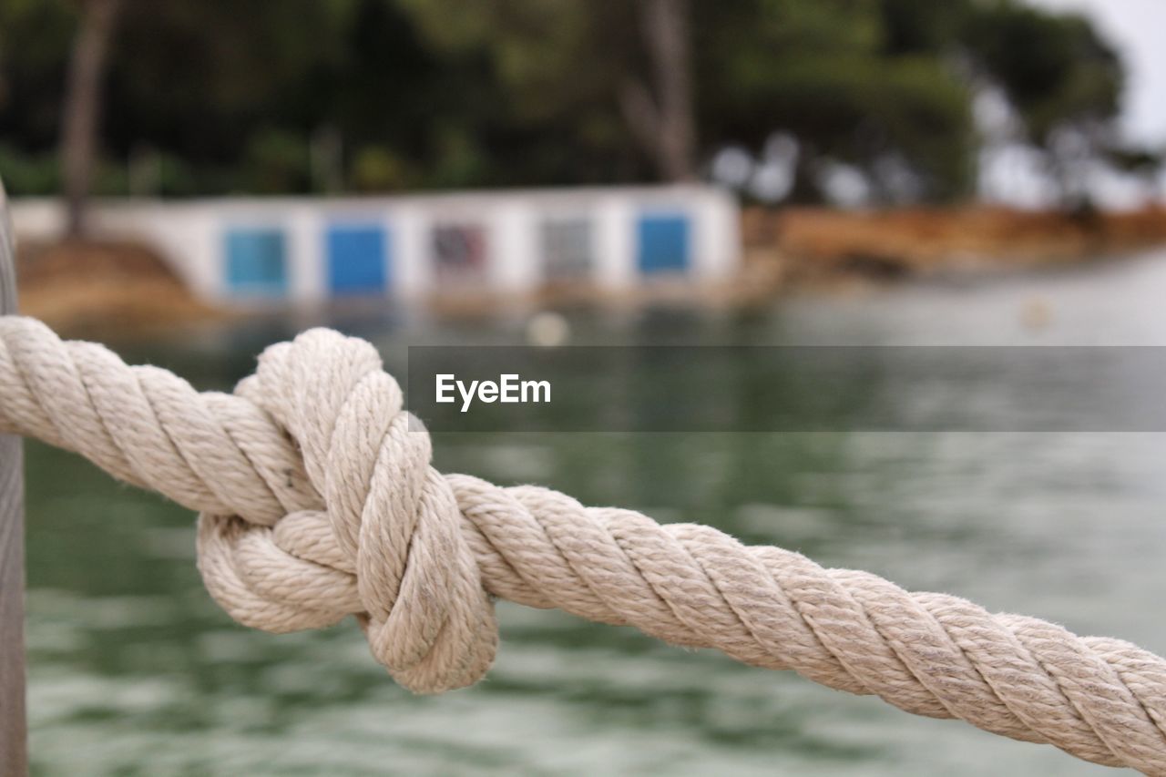 Close-up of rope tied to wooden post