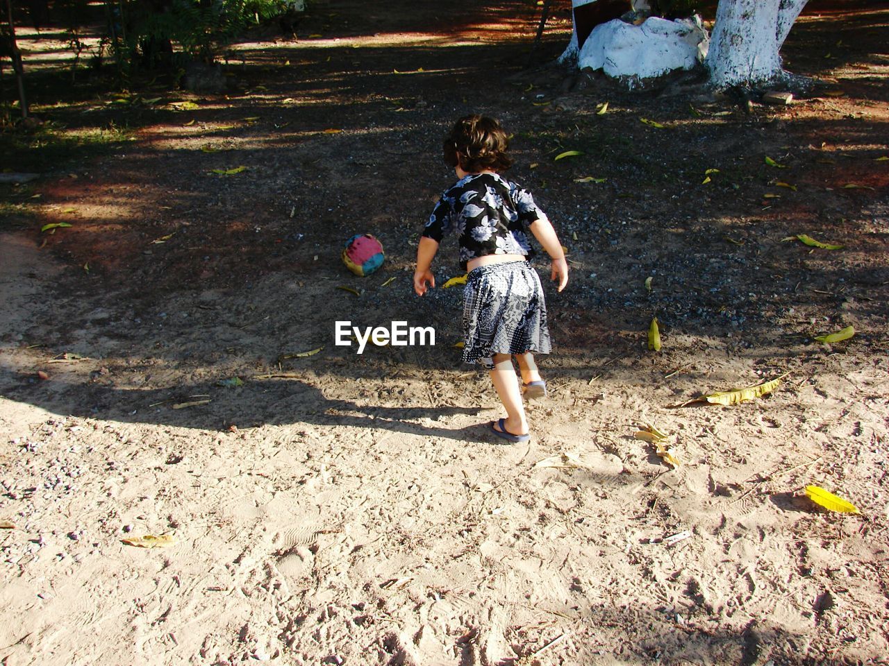 High angle view of girl playing with ball on field