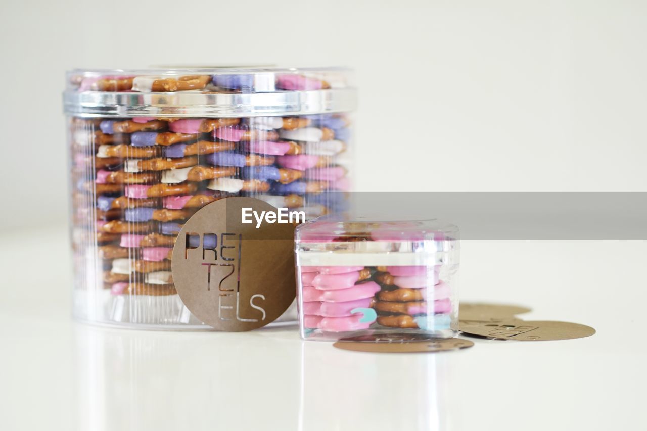 CLOSE-UP OF COINS IN GLASS JAR ON TABLE