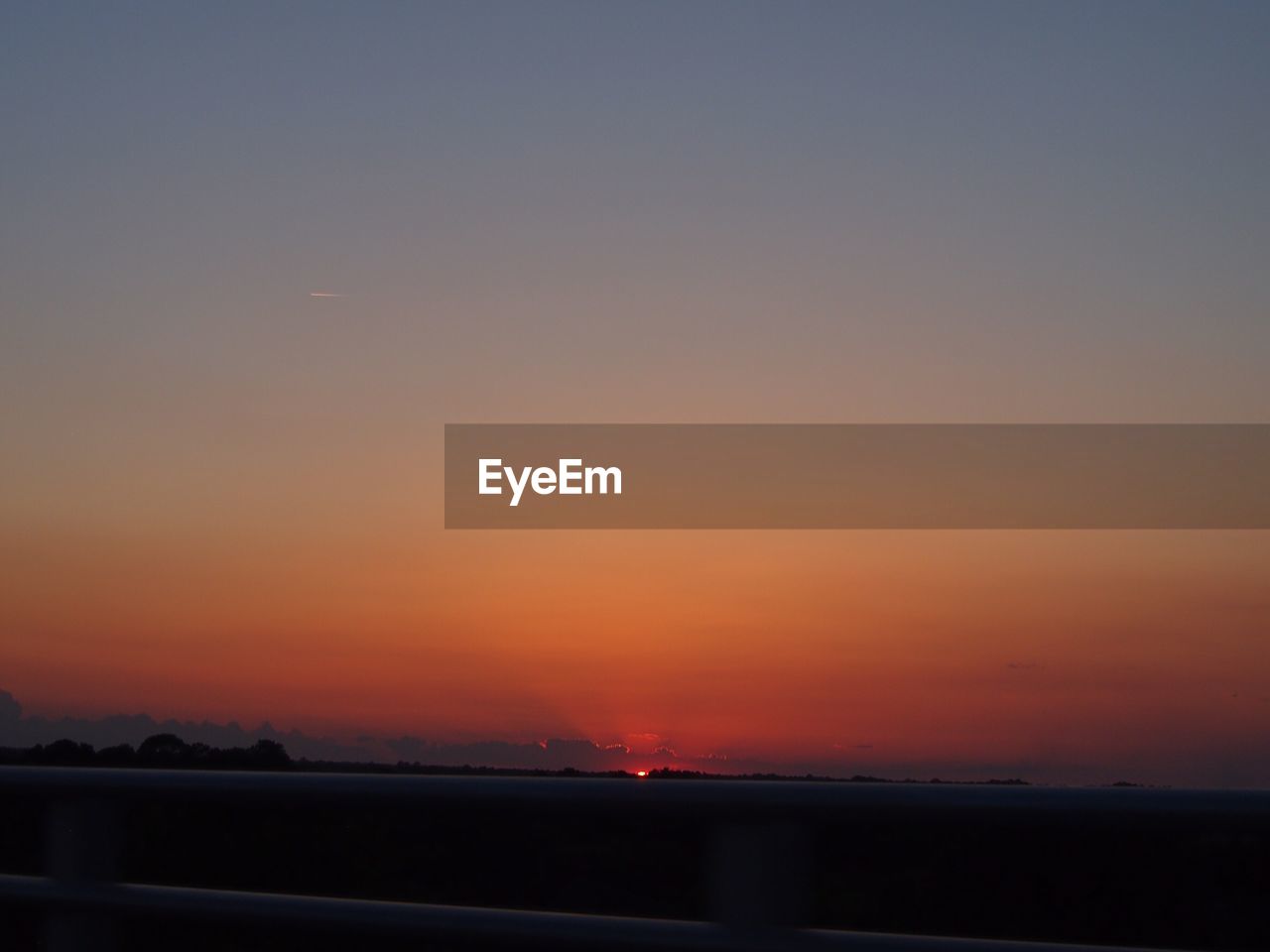 SCENIC VIEW OF SEA AGAINST ORANGE SKY DURING SUNSET