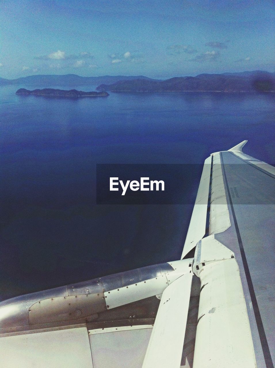 Cropped image of airplane flying above river