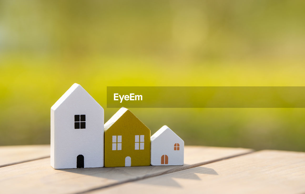 Wooden houses stand in a row outdoors on a sunny day. real estate and affordable housing concept.