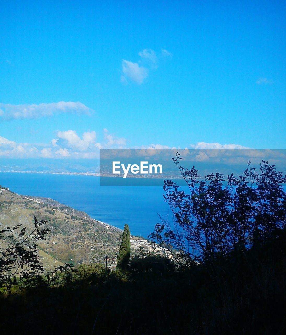 Scenic view of sea against blue sky