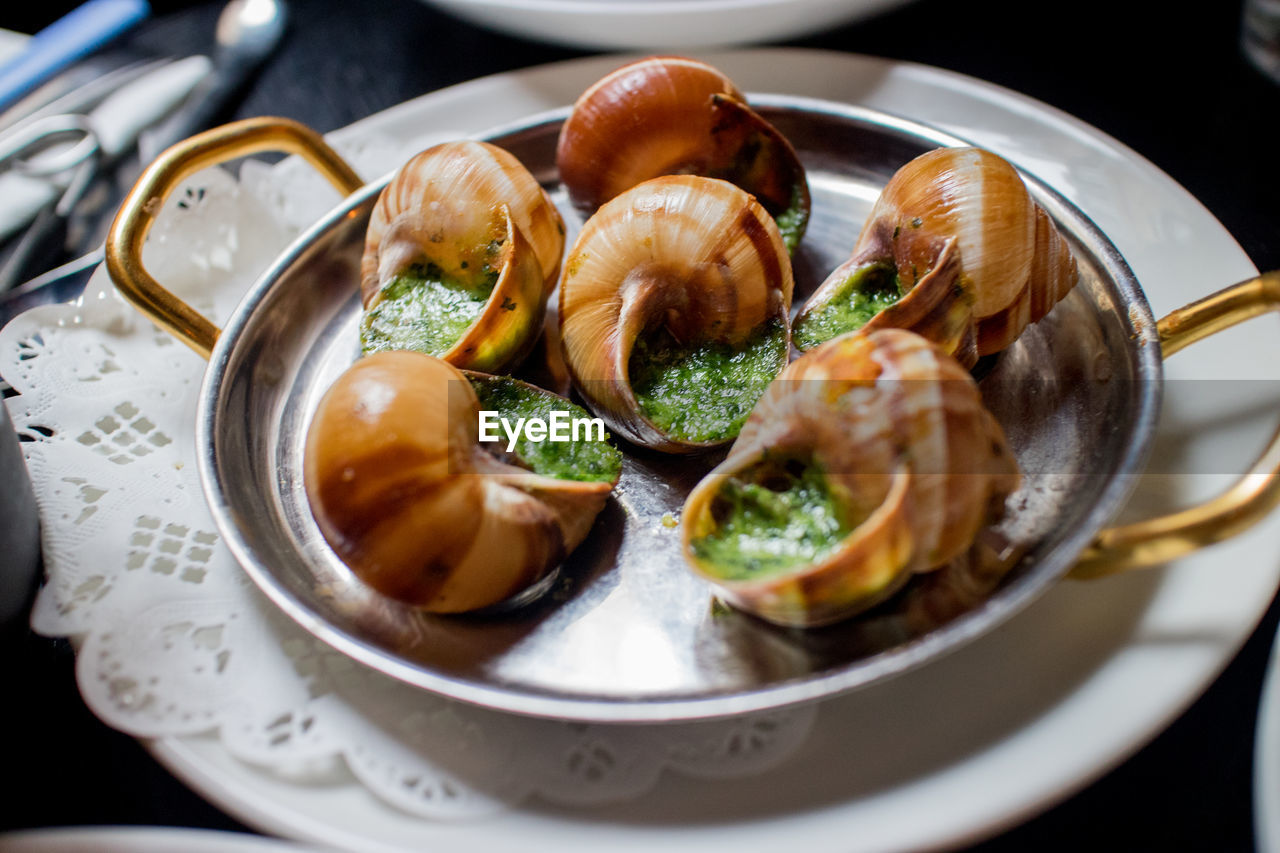 Close-up of snails in plate on table