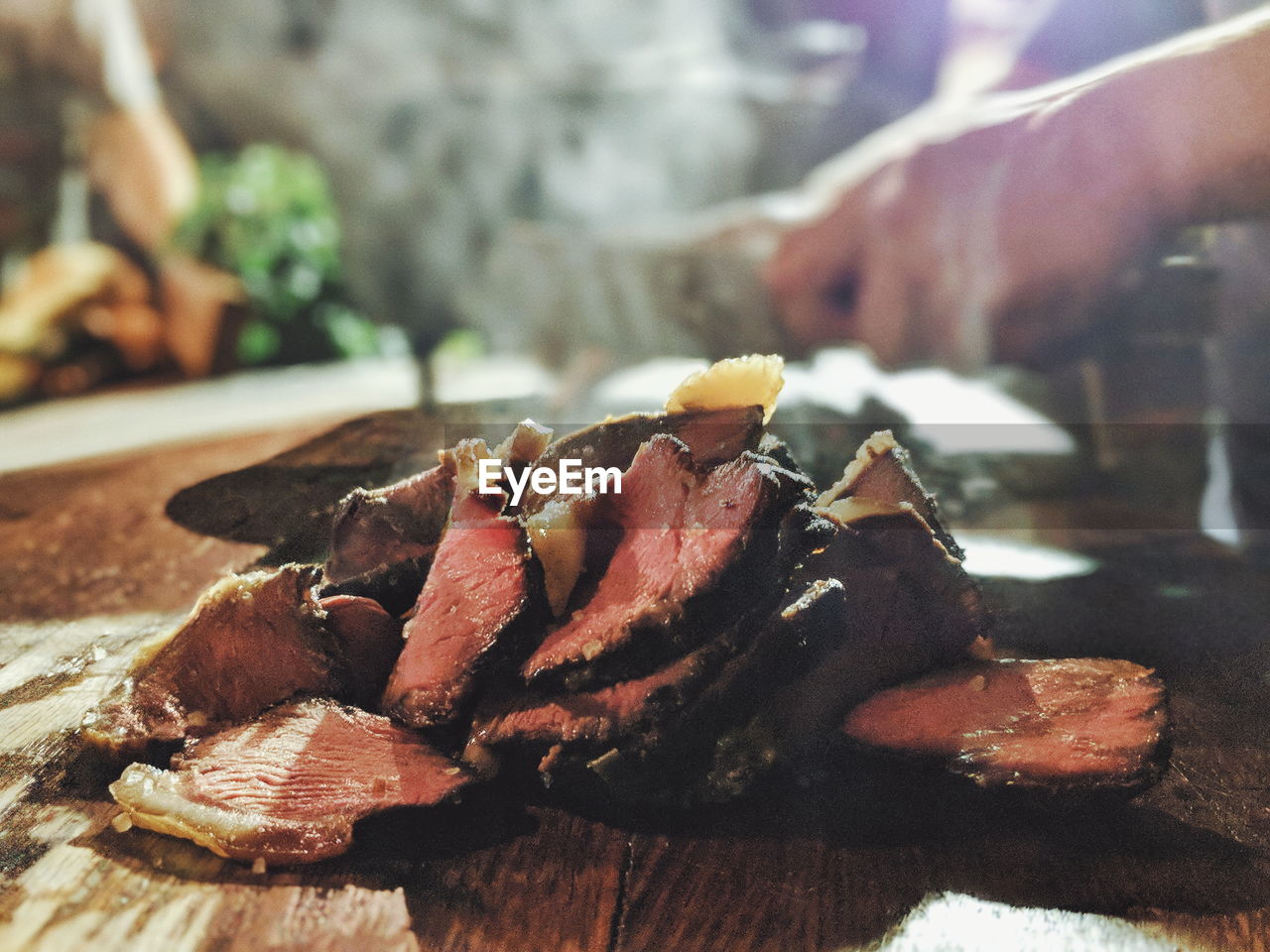 Cropped hand of person preparing food on table