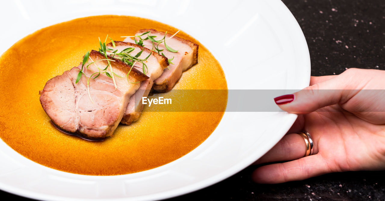 High angle view of woman holding food in plate