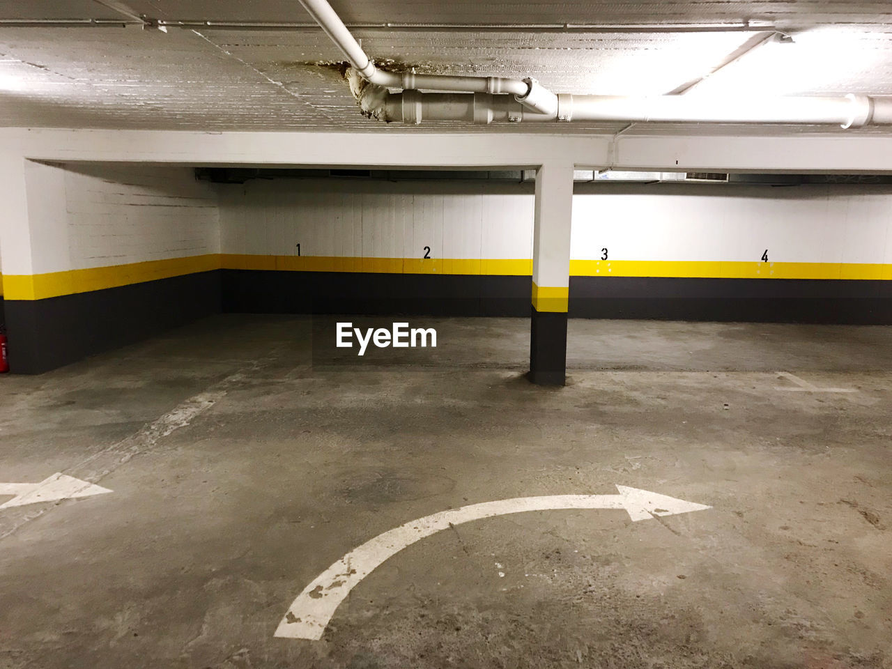 VIEW OF EMPTY PARKING LOT WITH YELLOW BACKGROUND