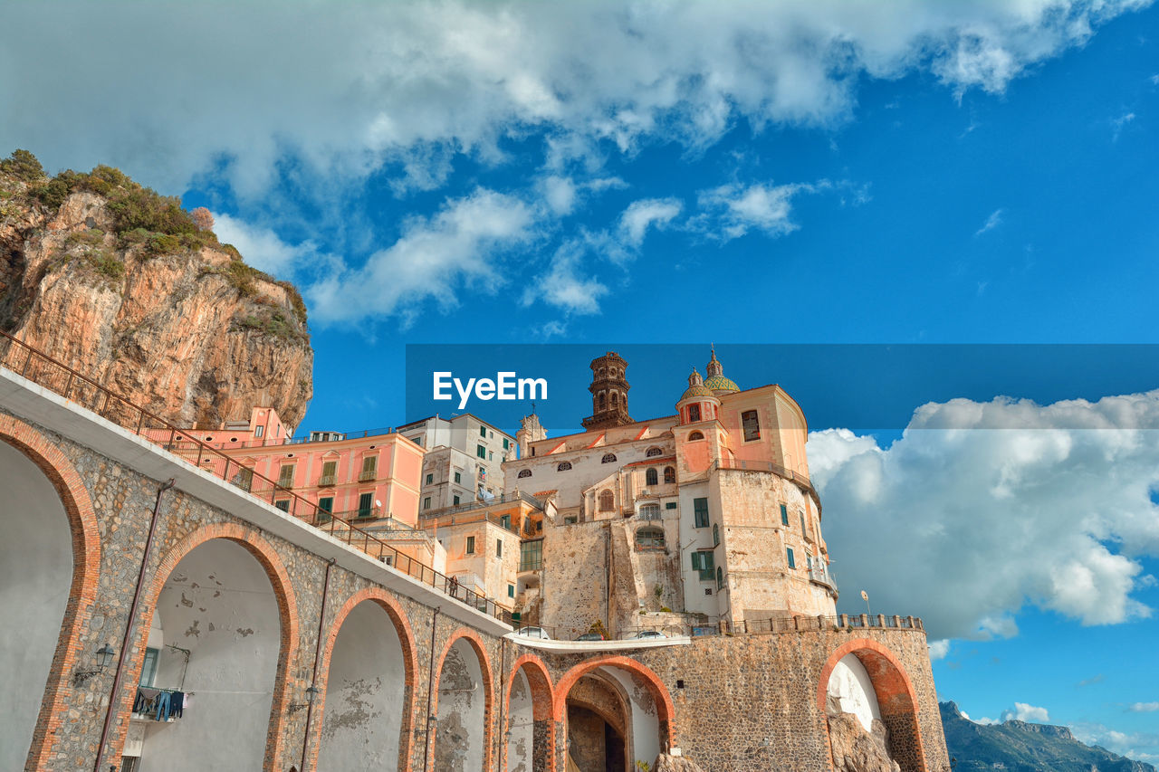 Amalfi coast at sunset, low angle view of old building against sky