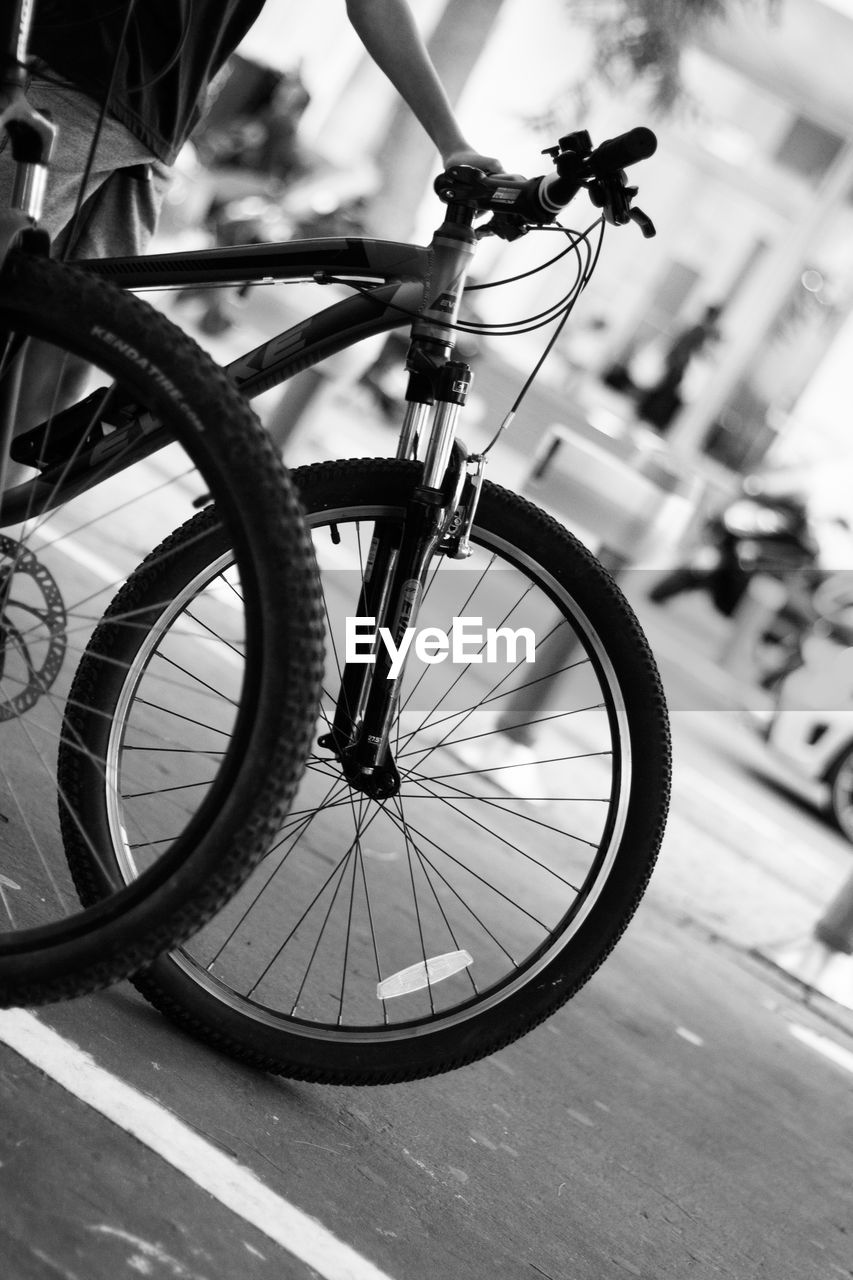 CLOSE-UP OF BICYCLE WHEEL AGAINST SKY