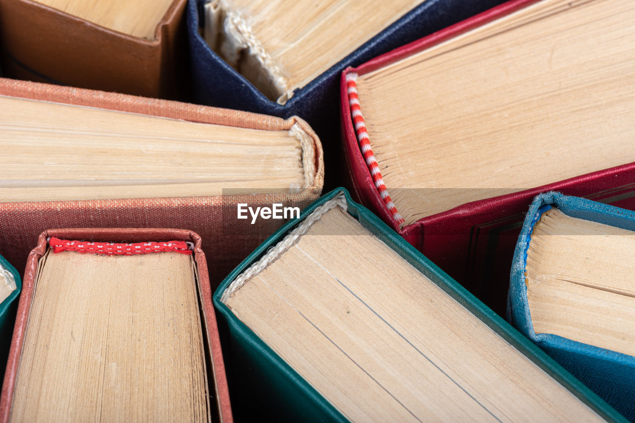 The spines of old books close up as a background. knowledge concept.