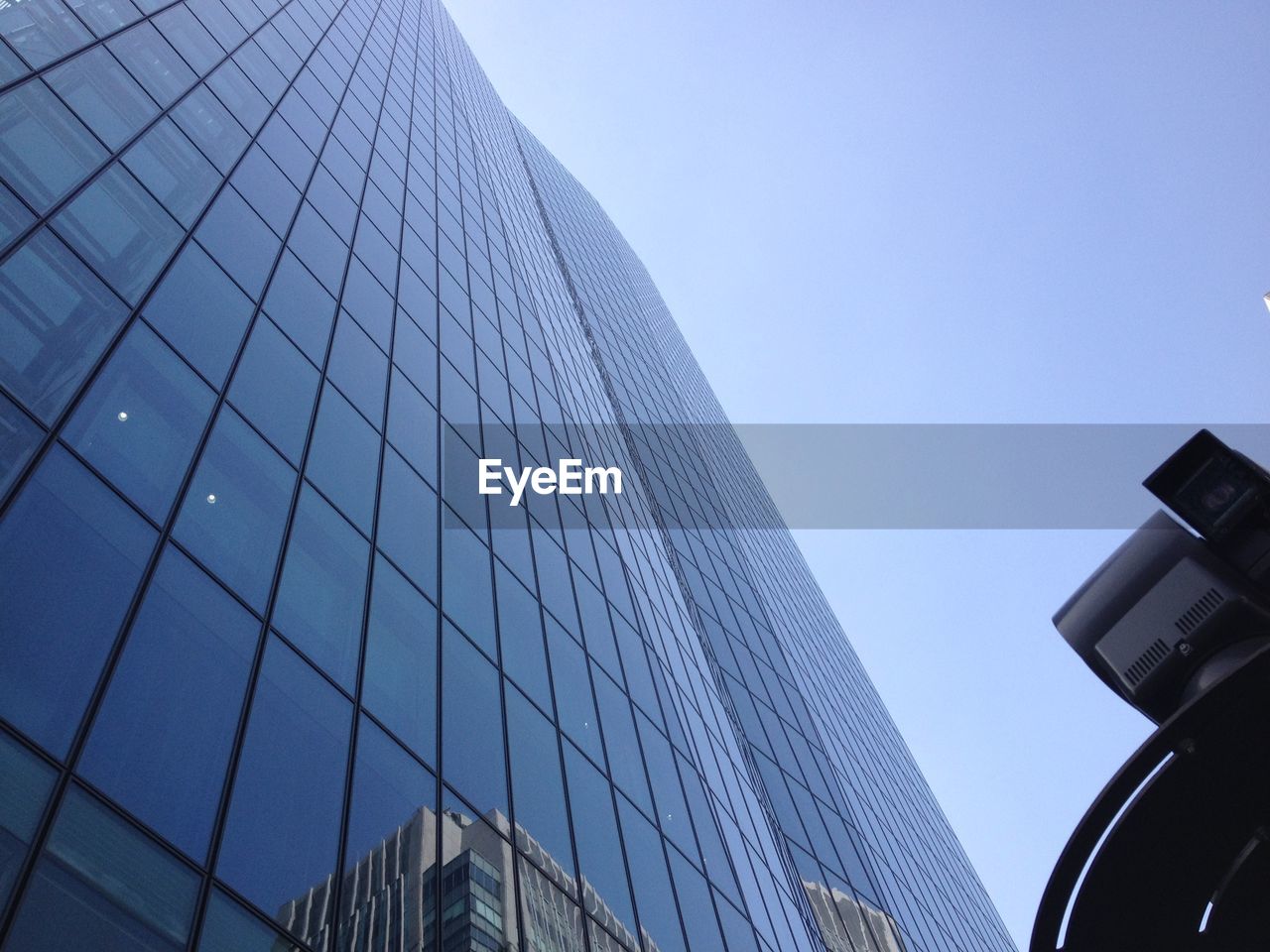 Low angle view of modern building against blue sky