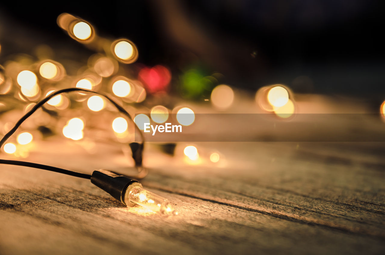 Close-up of illuminated string lights on table during christmas