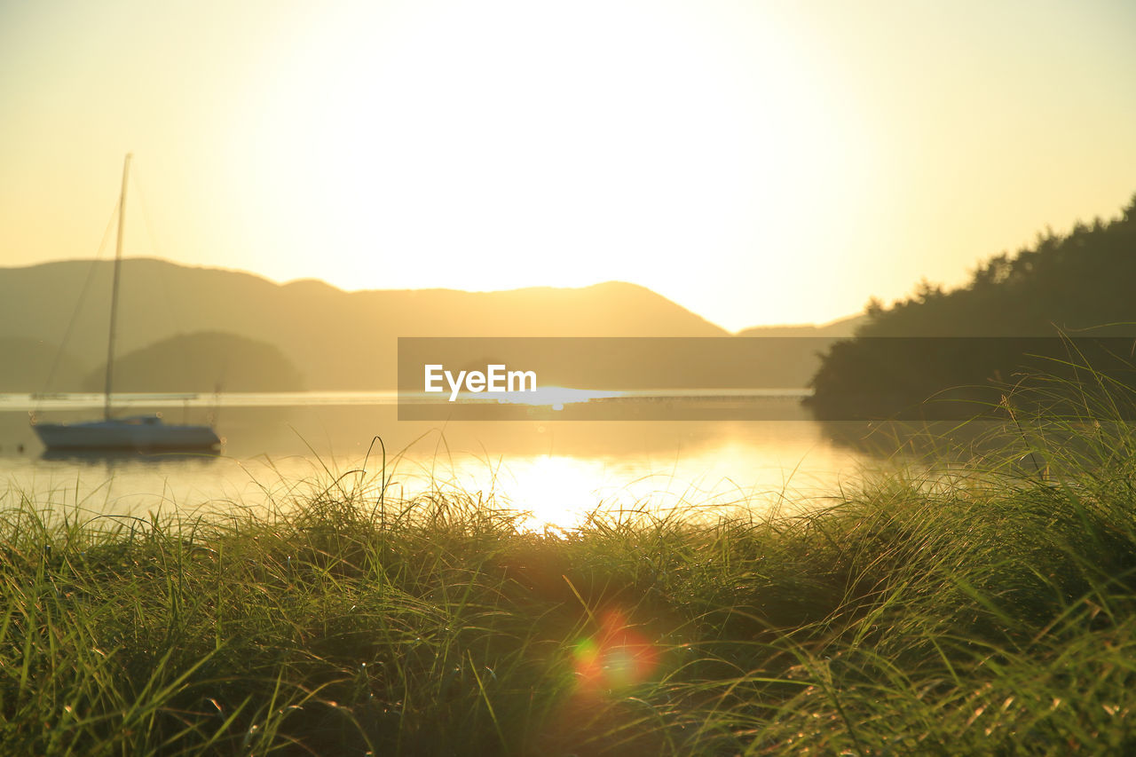 Scenic view of lake against sky during sunset