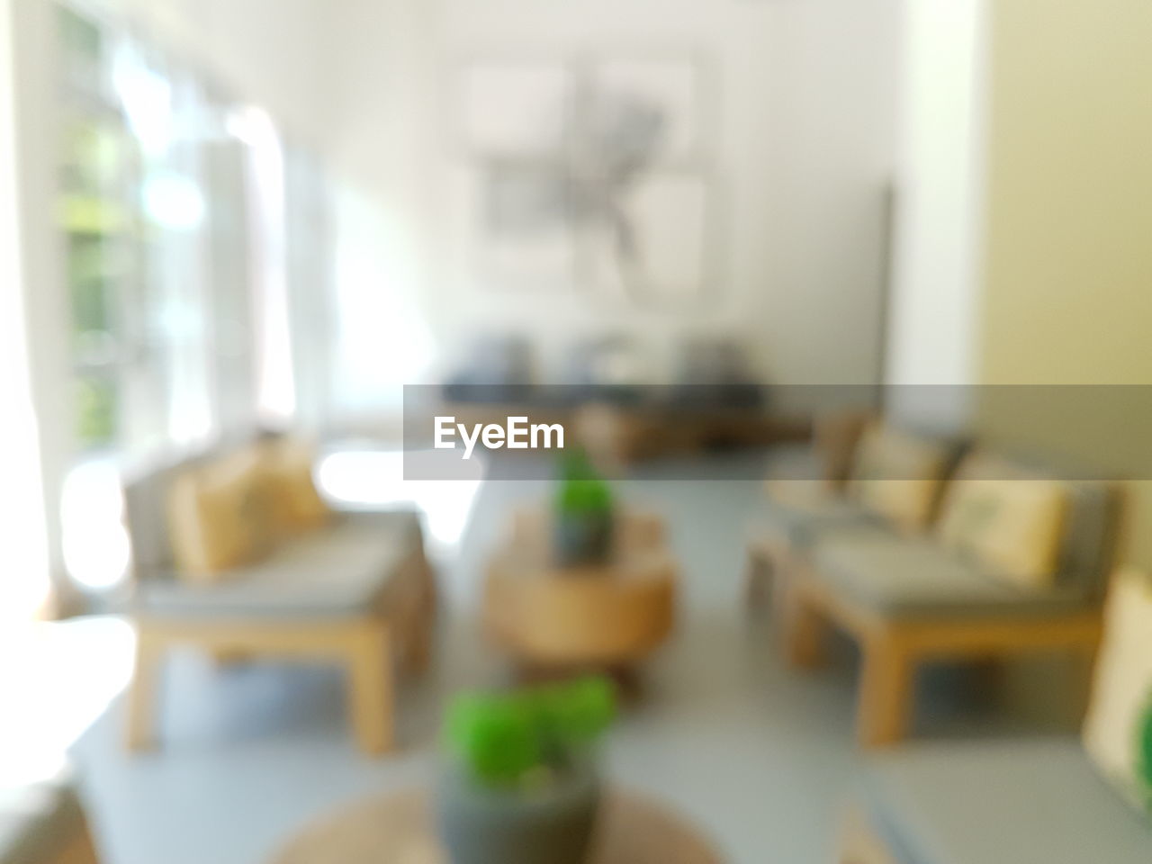 Defocused chairs and table on floor at home