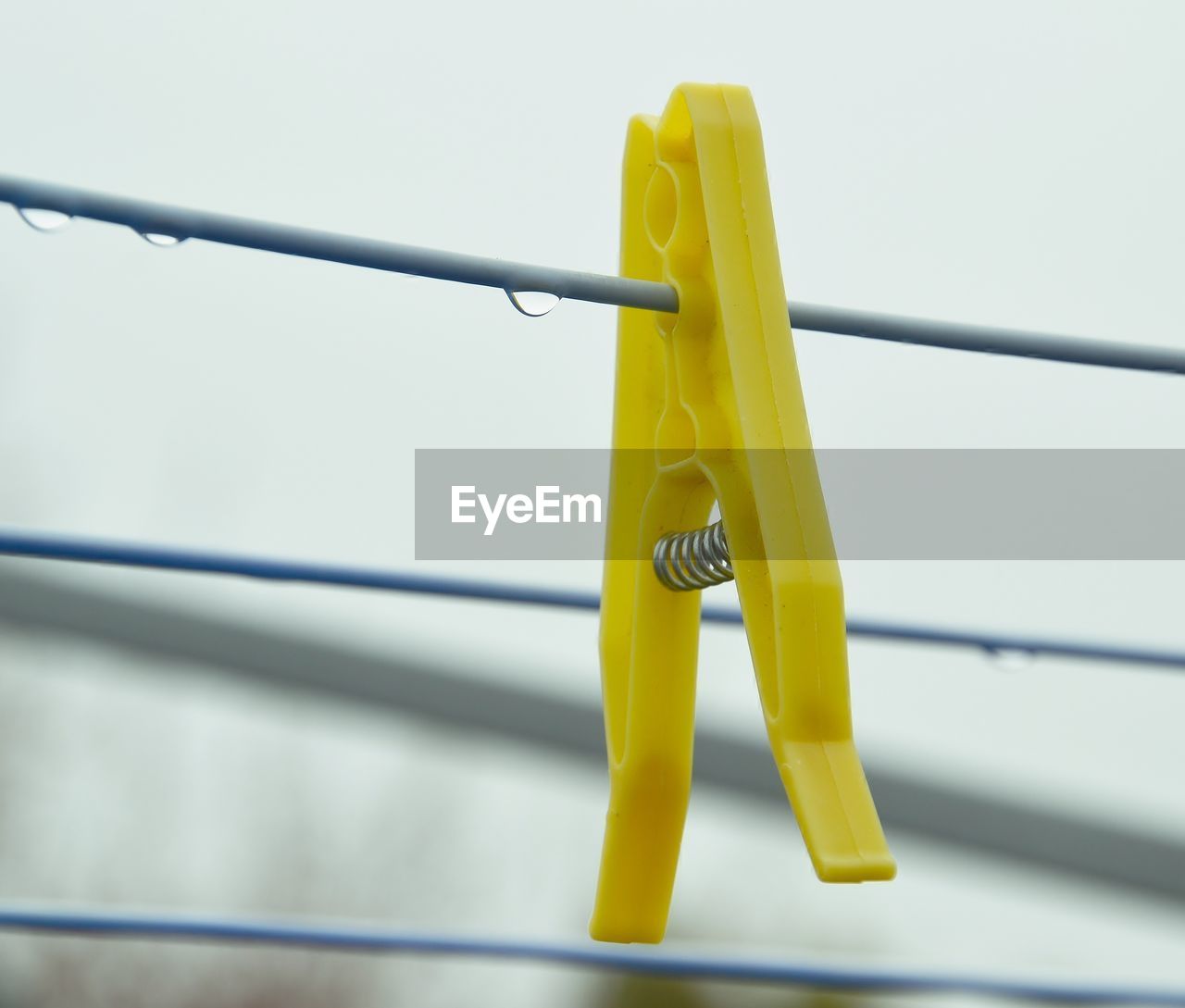 Close-up of yellow clothespin on clothesline