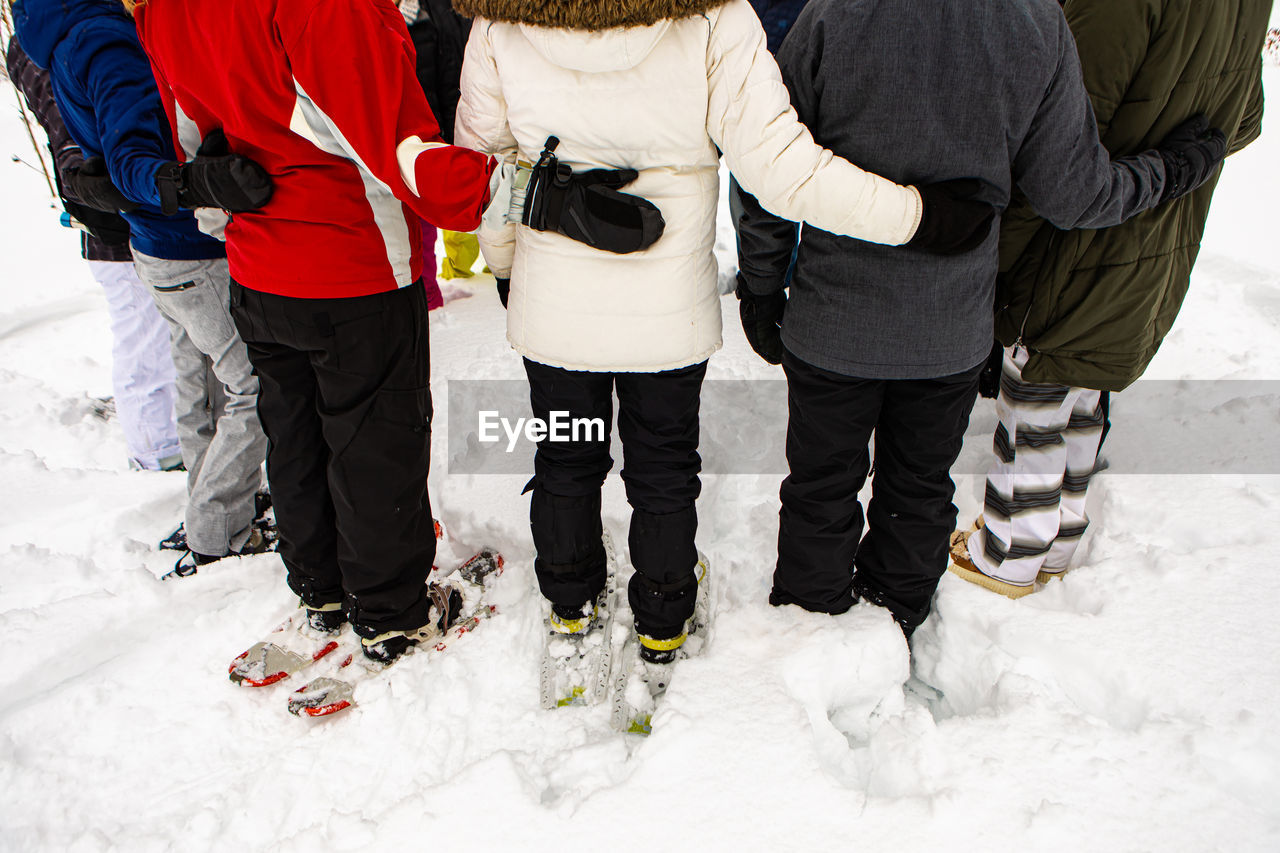 Rear view of people walking in snow