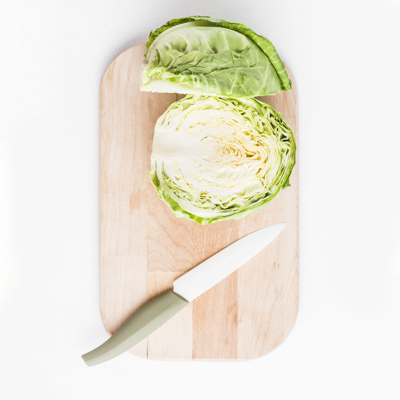 food and drink, food, healthy eating, vegetable, wellbeing, freshness, studio shot, produce, cutting board, indoors, wood, white background, cabbage, no people, raw food, organic, kitchen knife, still life, high angle view, cut out, copy space, green, lettuce, ingredient, directly above