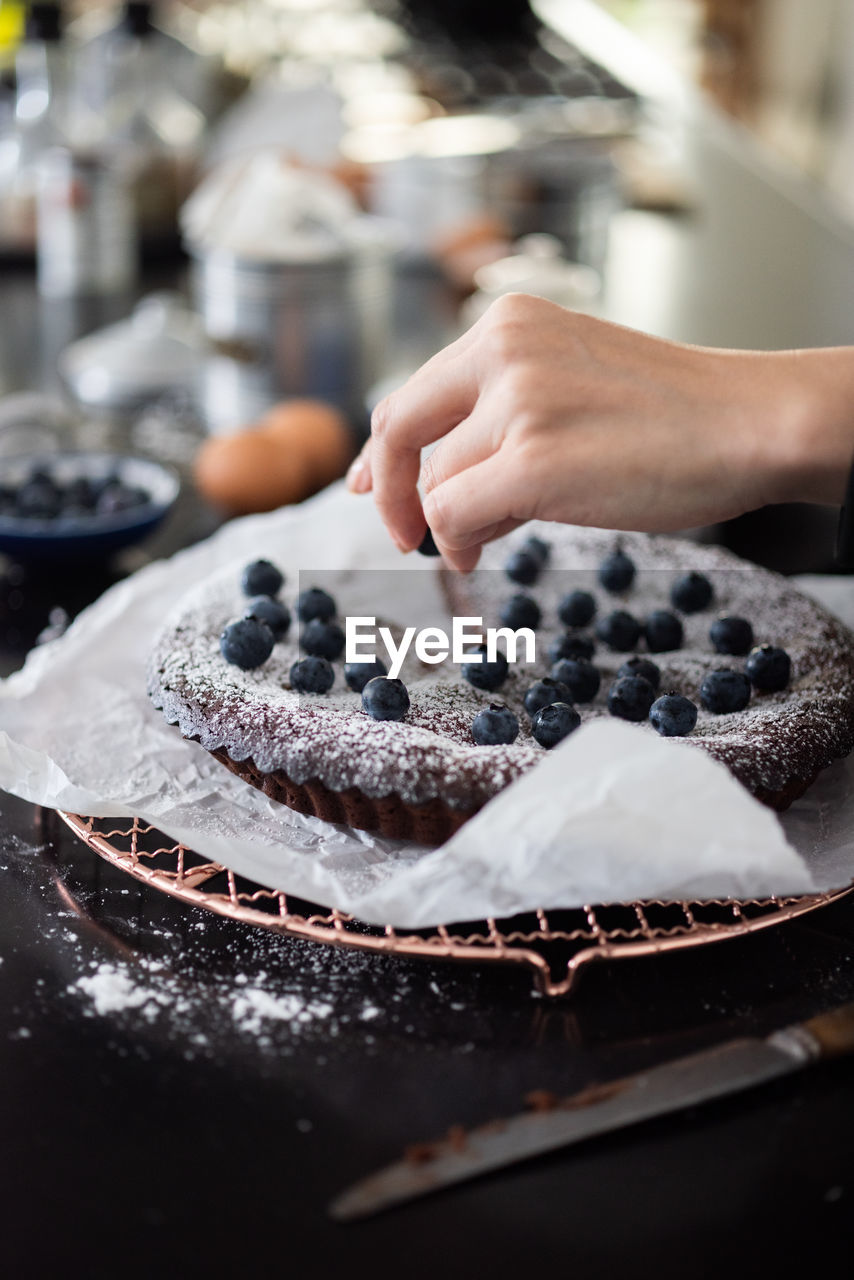 MIDSECTION OF PERSON WITH CAKE