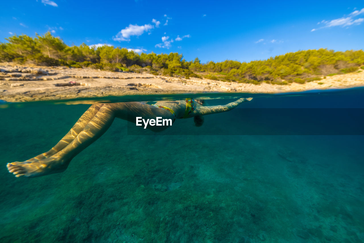 Girl diving in the adriatic sea on hvar island, croatia