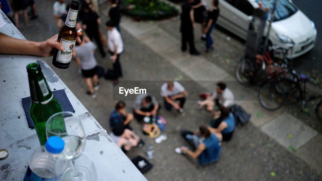 HIGH ANGLE VIEW OF PEOPLE AT STREET IN CITY