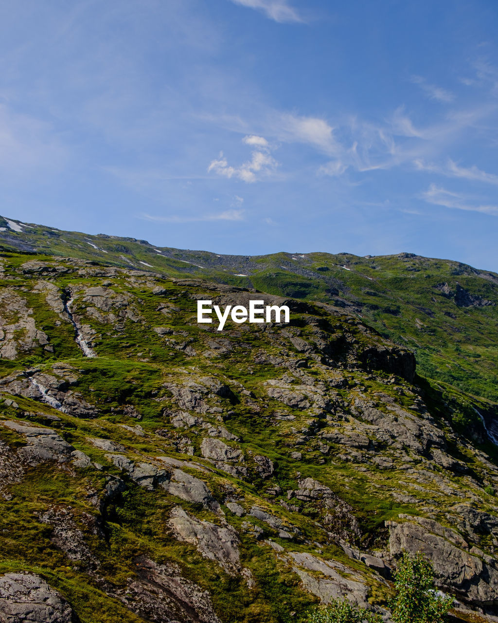 sky, environment, landscape, mountain, scenics - nature, nature, beauty in nature, rock, cloud, land, wilderness, plant, non-urban scene, no people, tranquility, travel, travel destinations, ridge, outdoors, day, tranquil scene, tourism, grass, cliff, coast, adventure, terrain, tree, green, sea, mountain range, water, activity, blue