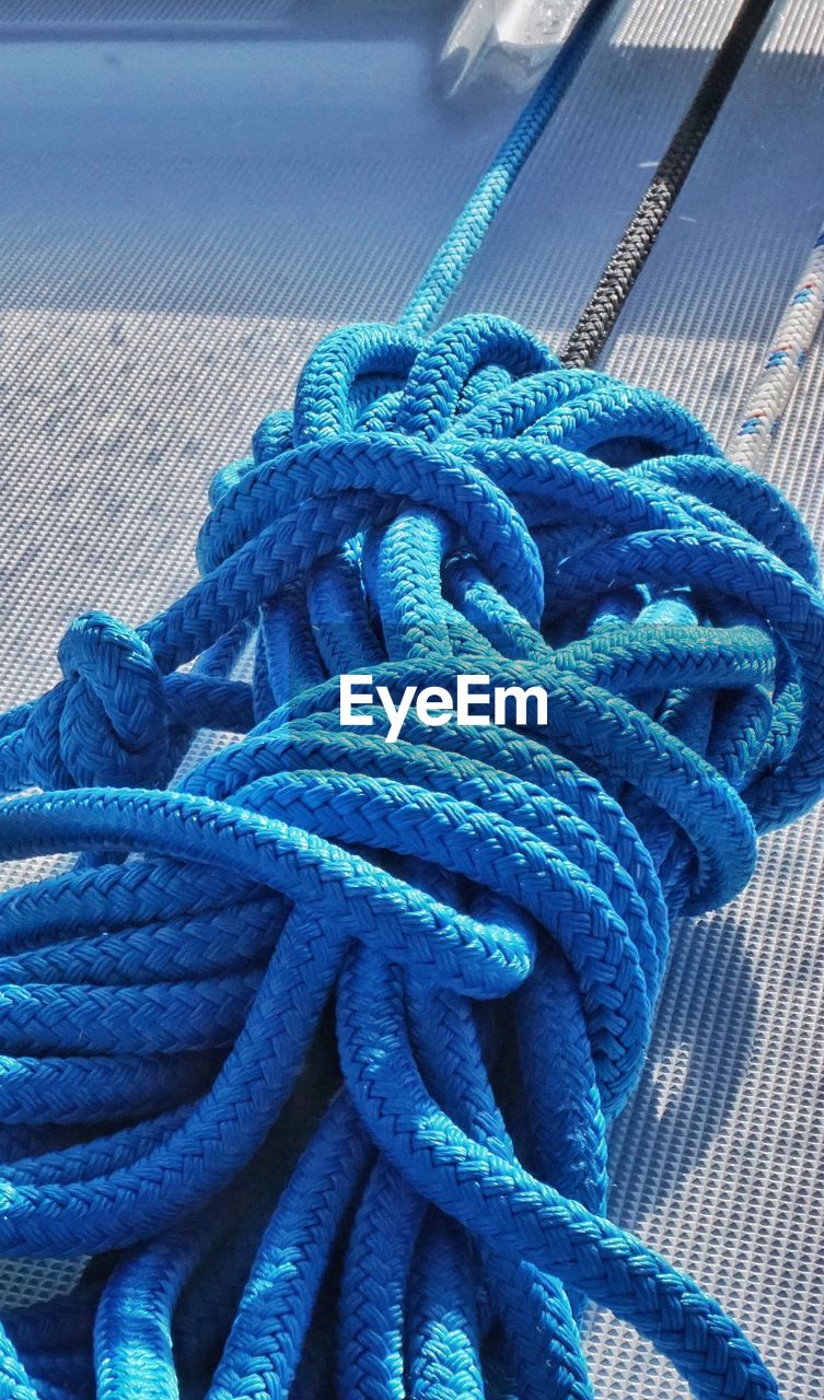 High angle view of blue tied ropes on boat