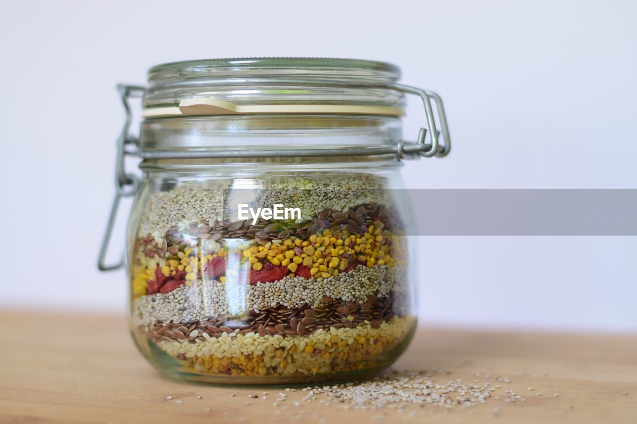 Close-up of various seeds in jar on table