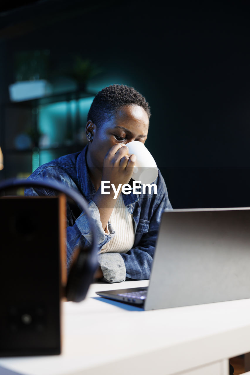 side view of man using laptop on table