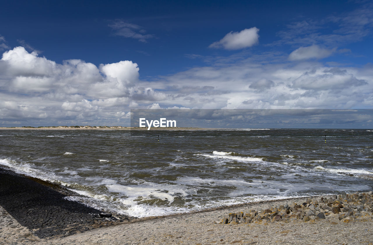 sea, water, sky, land, beach, shore, body of water, ocean, cloud, wave, horizon, coast, nature, scenics - nature, beauty in nature, sand, environment, wind wave, motion, travel, travel destinations, no people, water sports, day, sports, rock, landscape, outdoors, coastline, tourism, blue, horizon over water, tranquility, seascape, water's edge, sunlight, bay