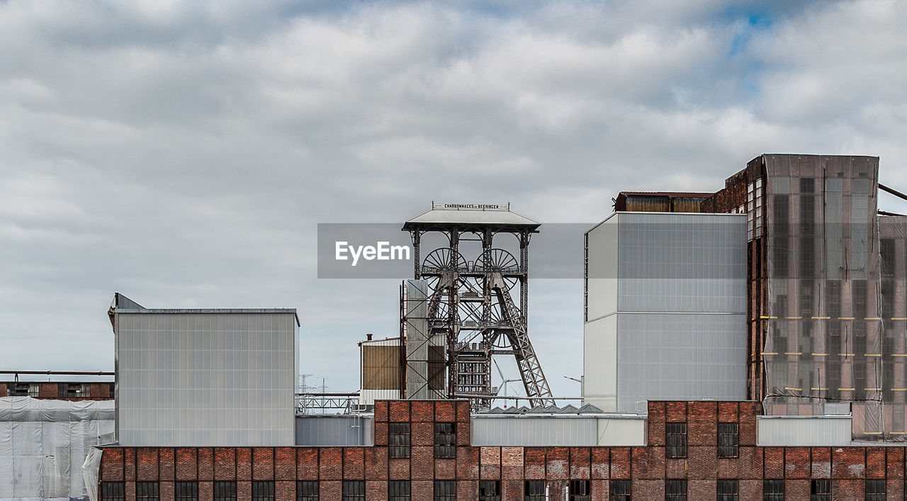 Low angle view of industrial building against sky