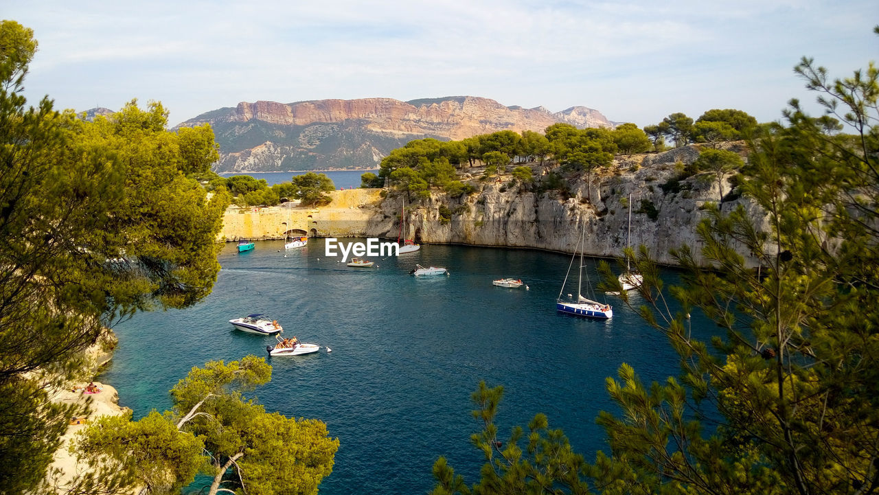 High angle view of sailboats by sea against sky